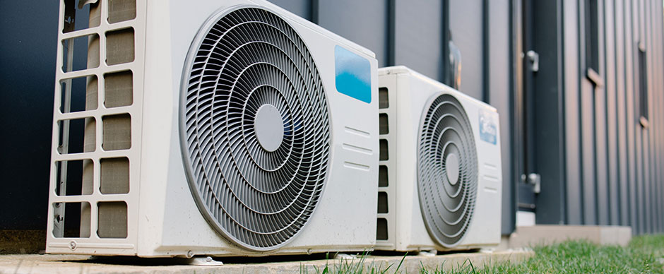 Heat pumps sitting outside of a home